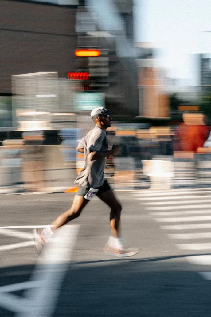 A runner mid-stride on a city street